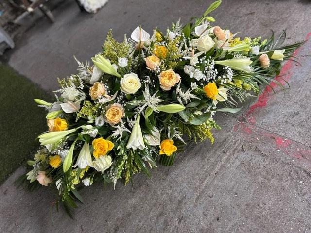 White and yellow casket spray
