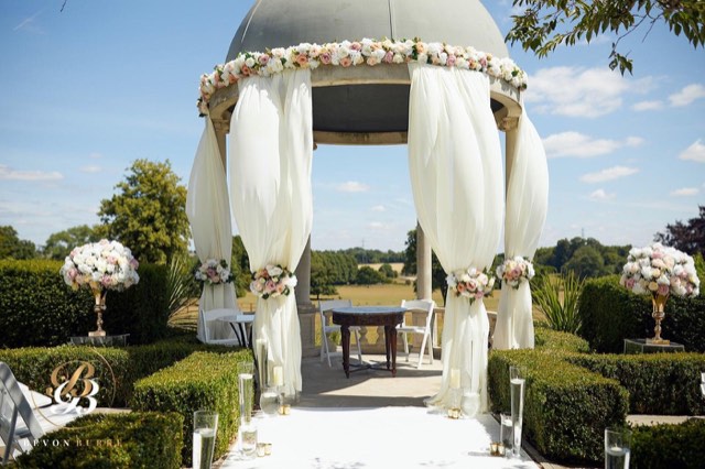 Garden gazebo draped for a wedding ceremony